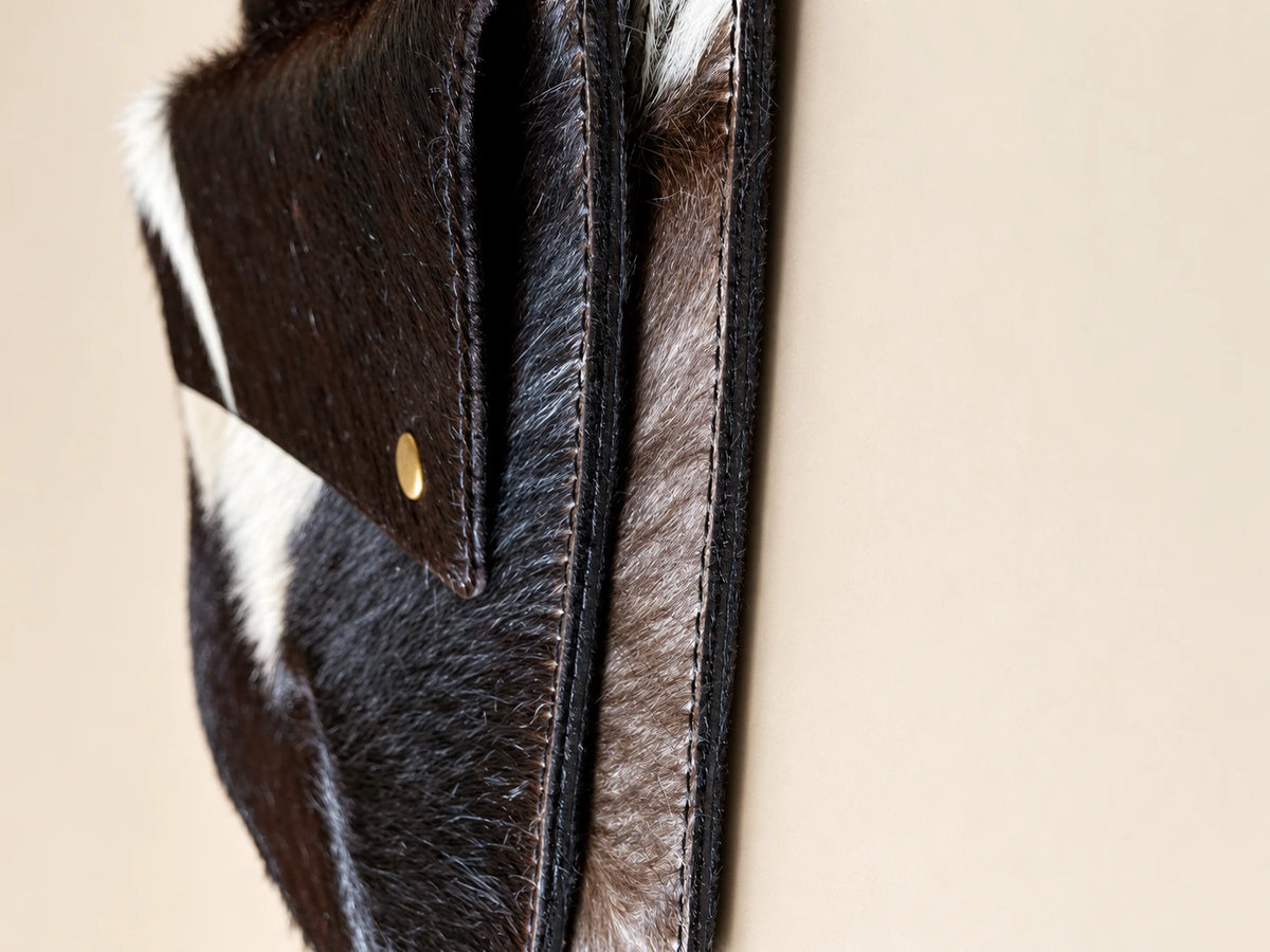 ADEEM sleeve detail showing layered flap, natural hair and edge stitching