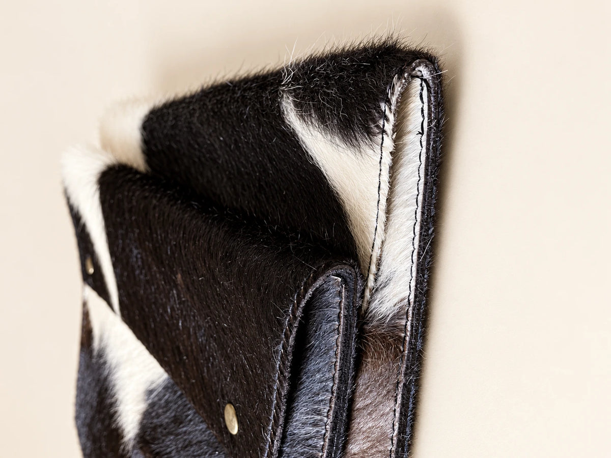 Low-angle close-up of ADEEM cowhide sleeve edges and hand stitching